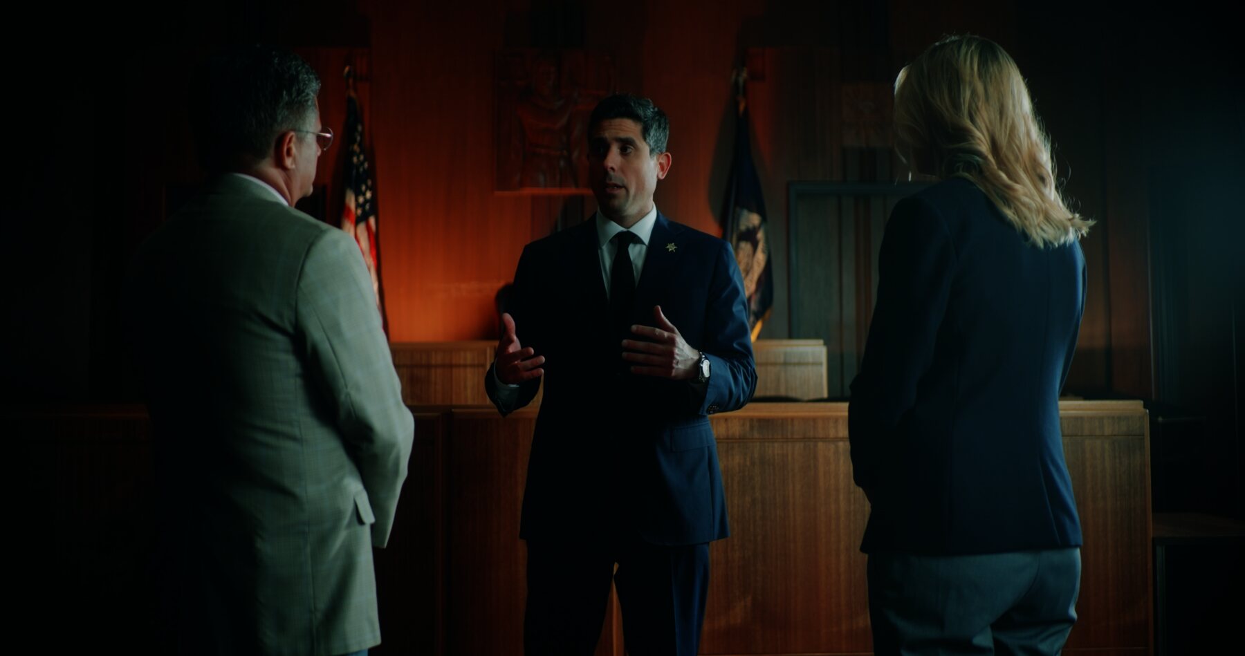 Marko Marjanovic speaking with attorneys in the courtroom